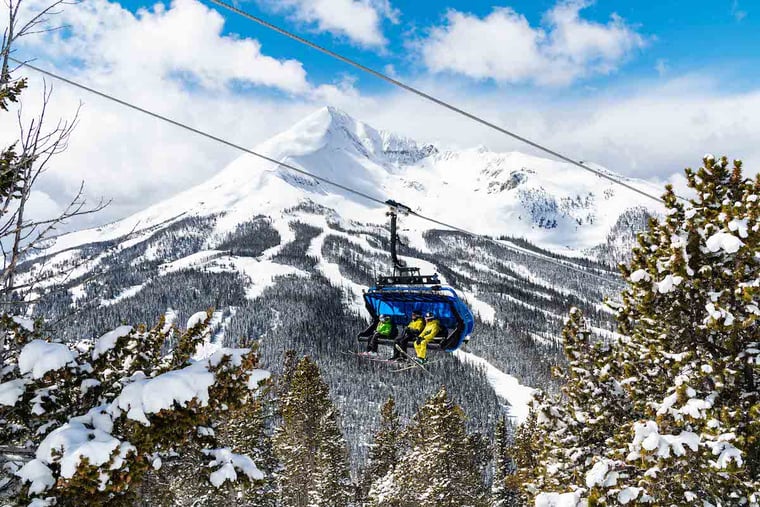 Three people on a lift at Big Sky Resort.