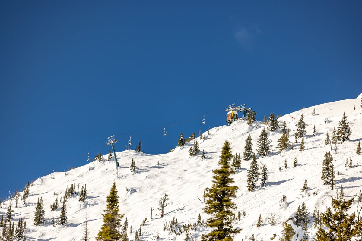 Bridger Bowl Ski Area lift going up the side of a mountain.
