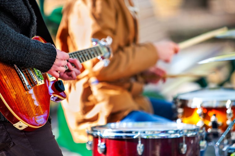 Person playing guitar at a festival