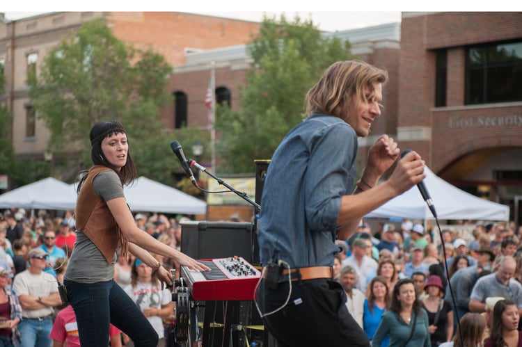 A singer and a woman on the keyboard perform in front of a crowd of people at Music on Main in Bozeman