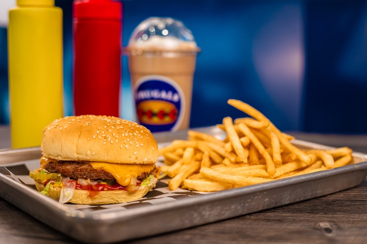 A burger, fries, and a milkshake on a tray at Frugals.