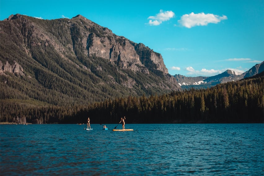Three people paddleboarding on Hyalite Reservoir.