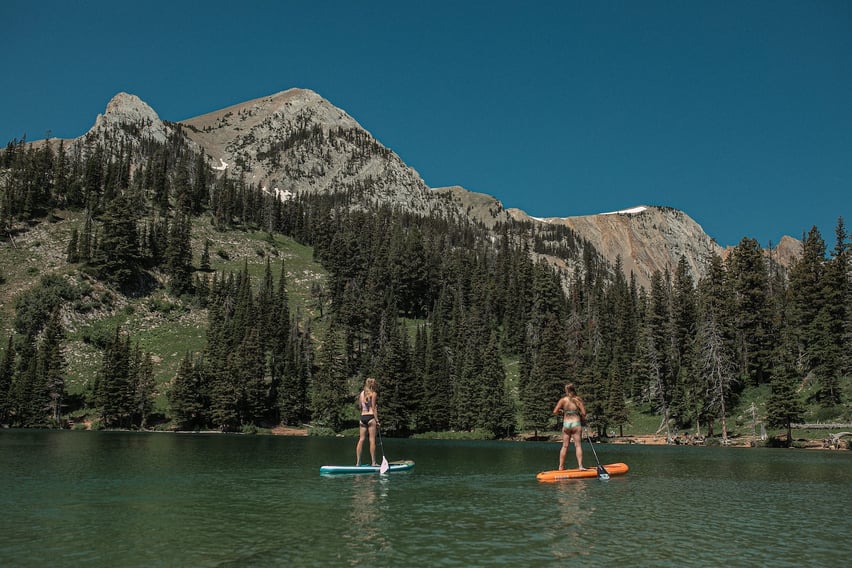 Two people stand up paddle boarding on Fairy Lake.