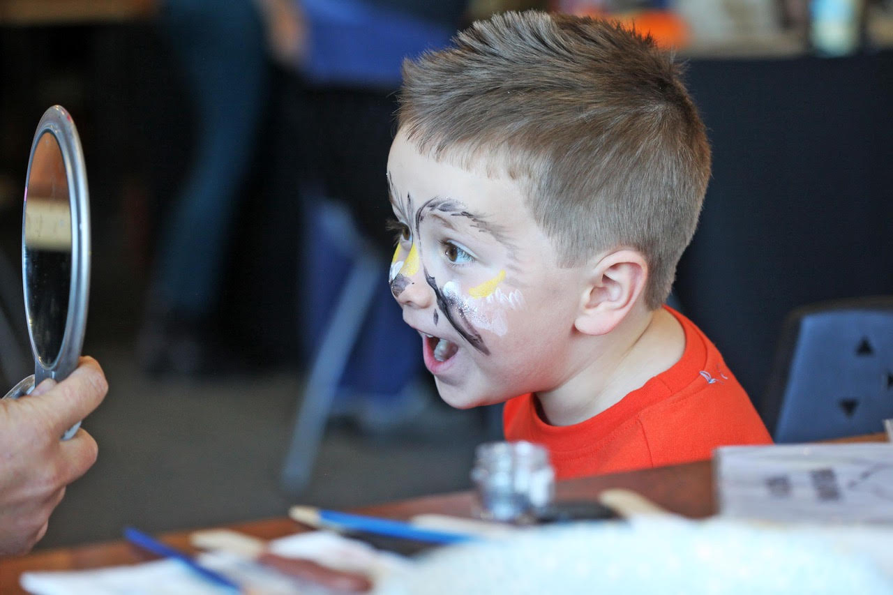boy views his owl face painting