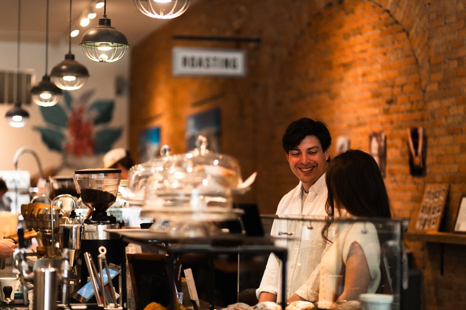 Two people ordering from Rockford Coffee Roasters.