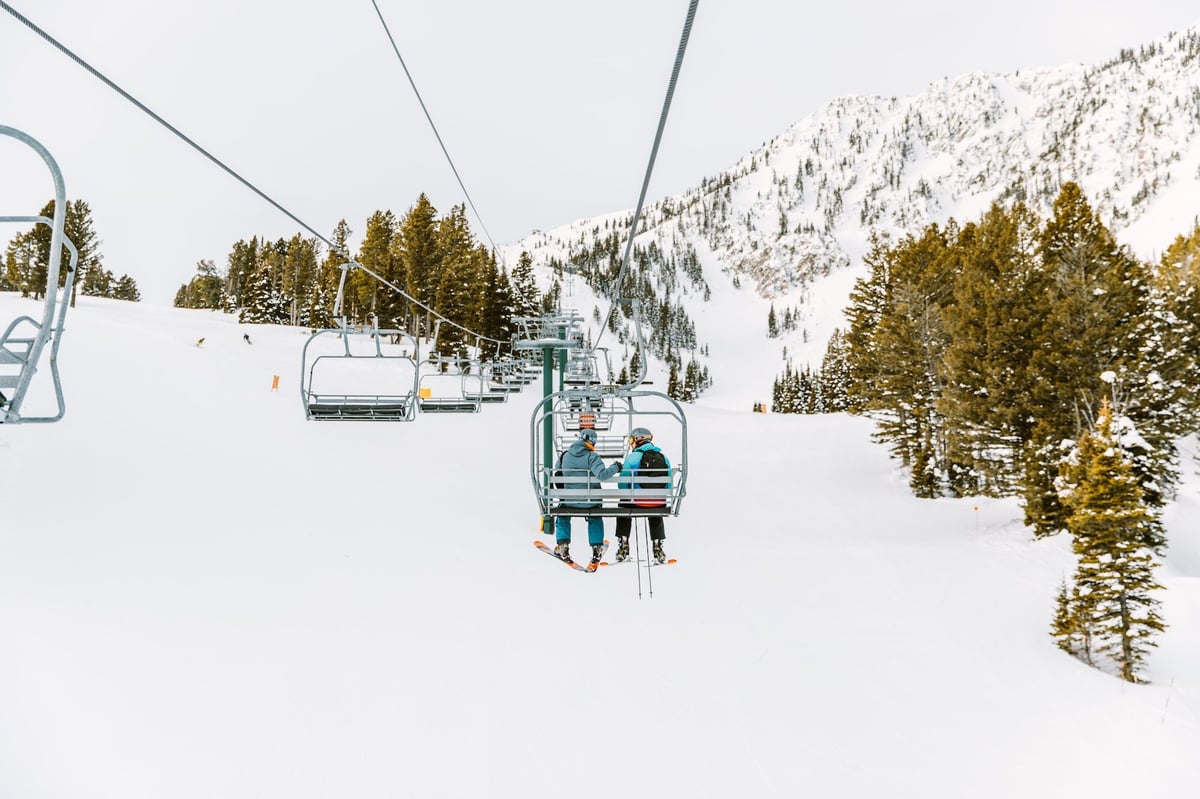Two people taking the ski lift to Bridger Bowl in Bozeman.