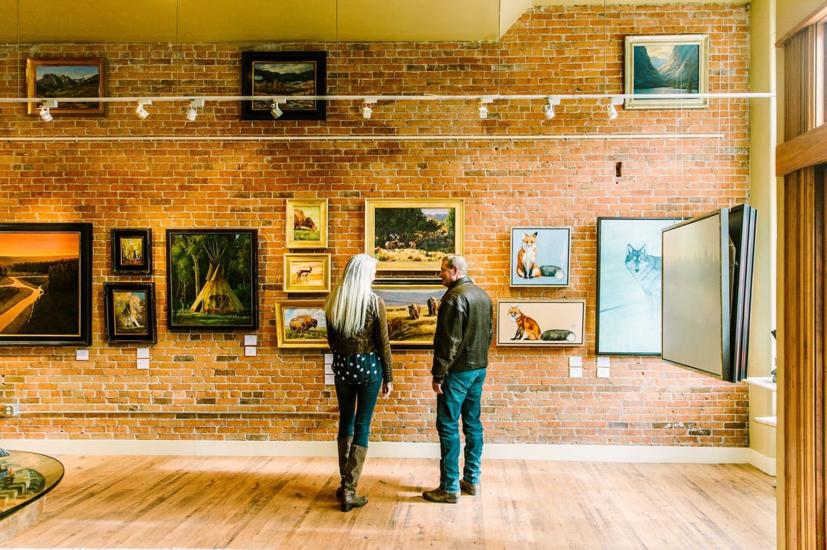 A couple viewing art at a gallery in Bozeman.