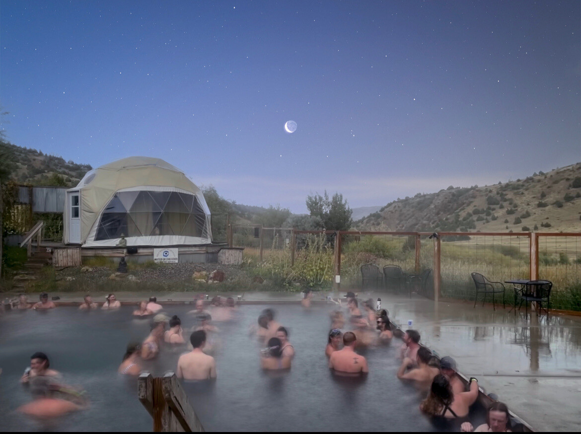 Photo of people in Norris Hot Springs at night