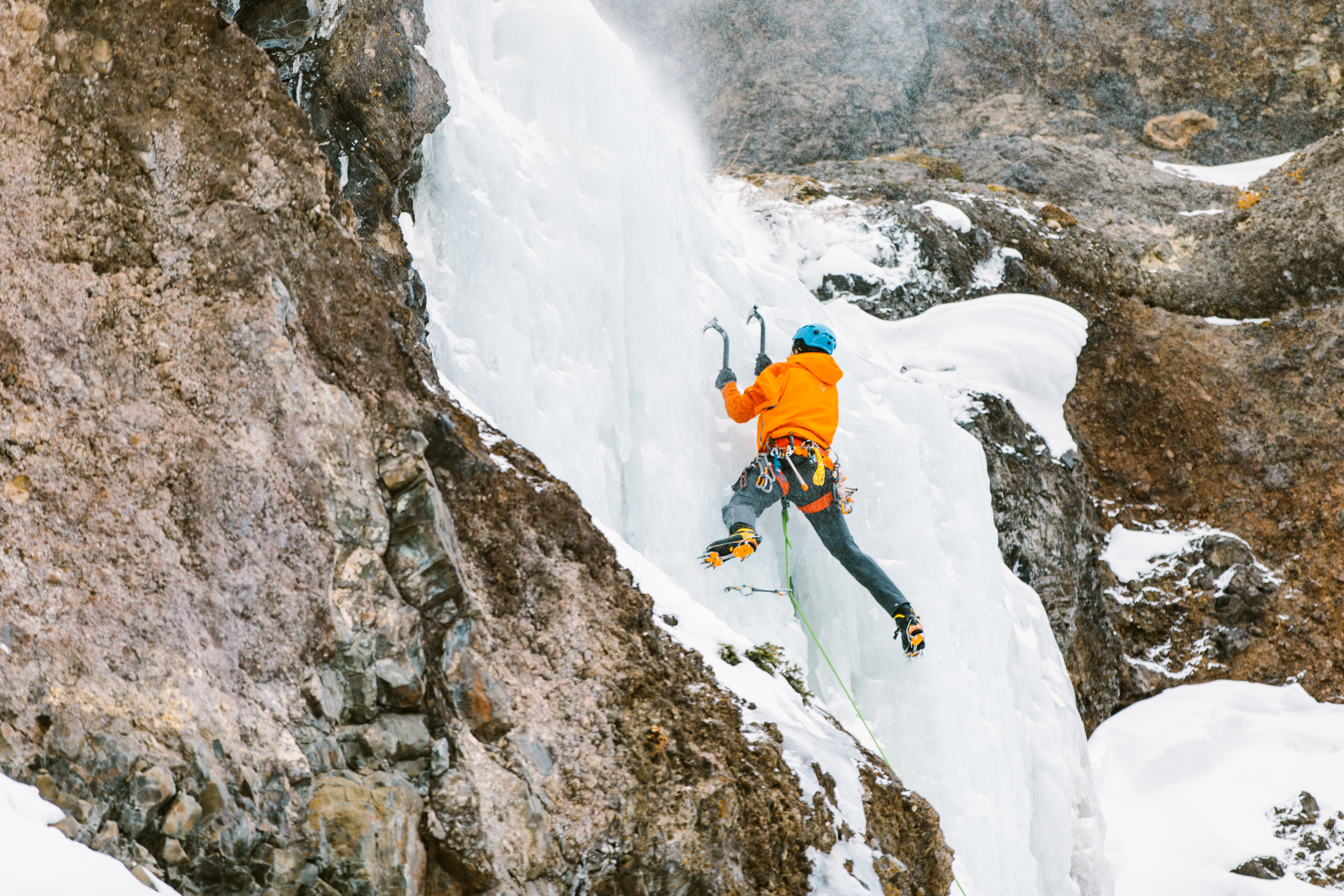 man ice climbing in Hyalite Canyon