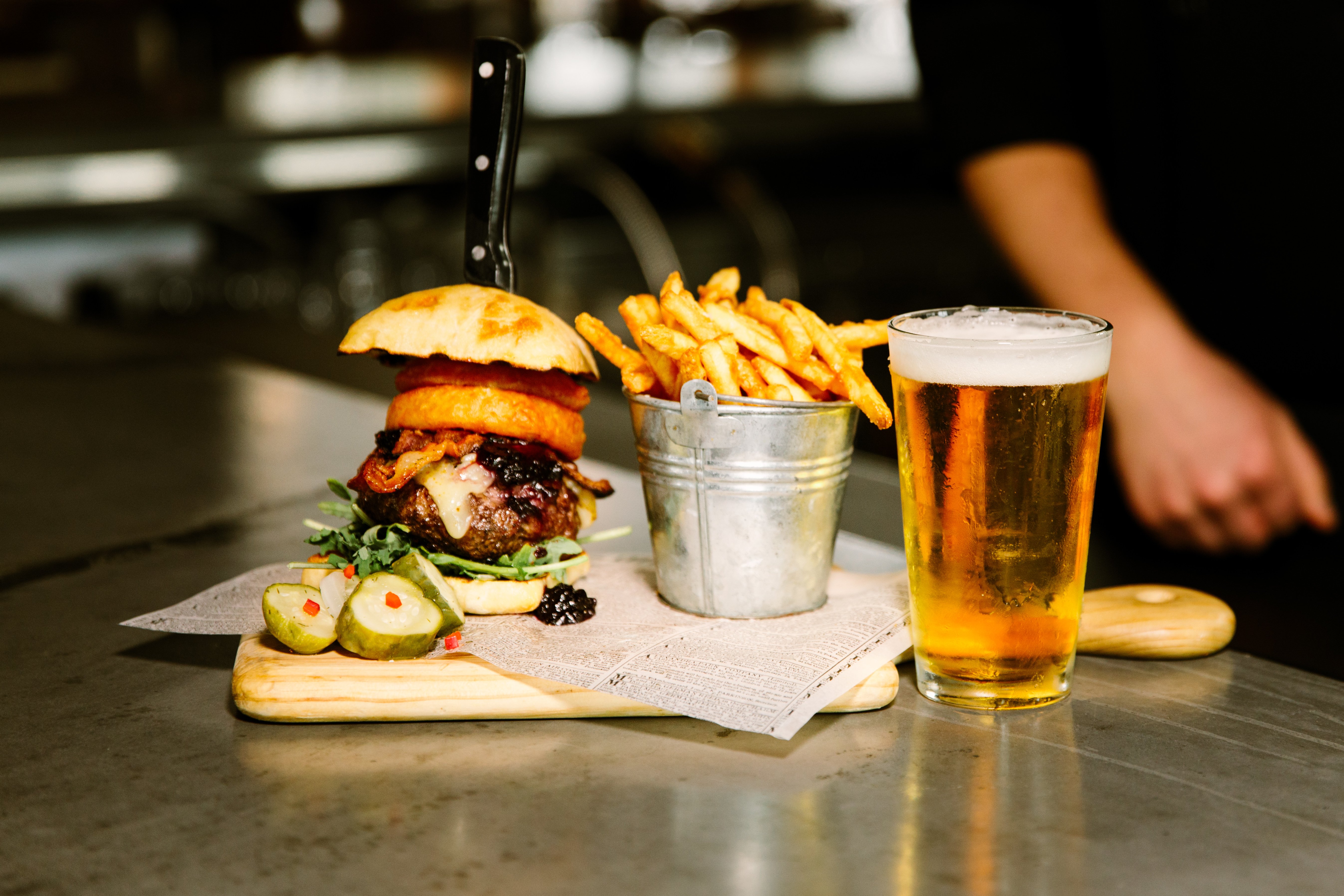 Photo of burger, fries, and a beer
