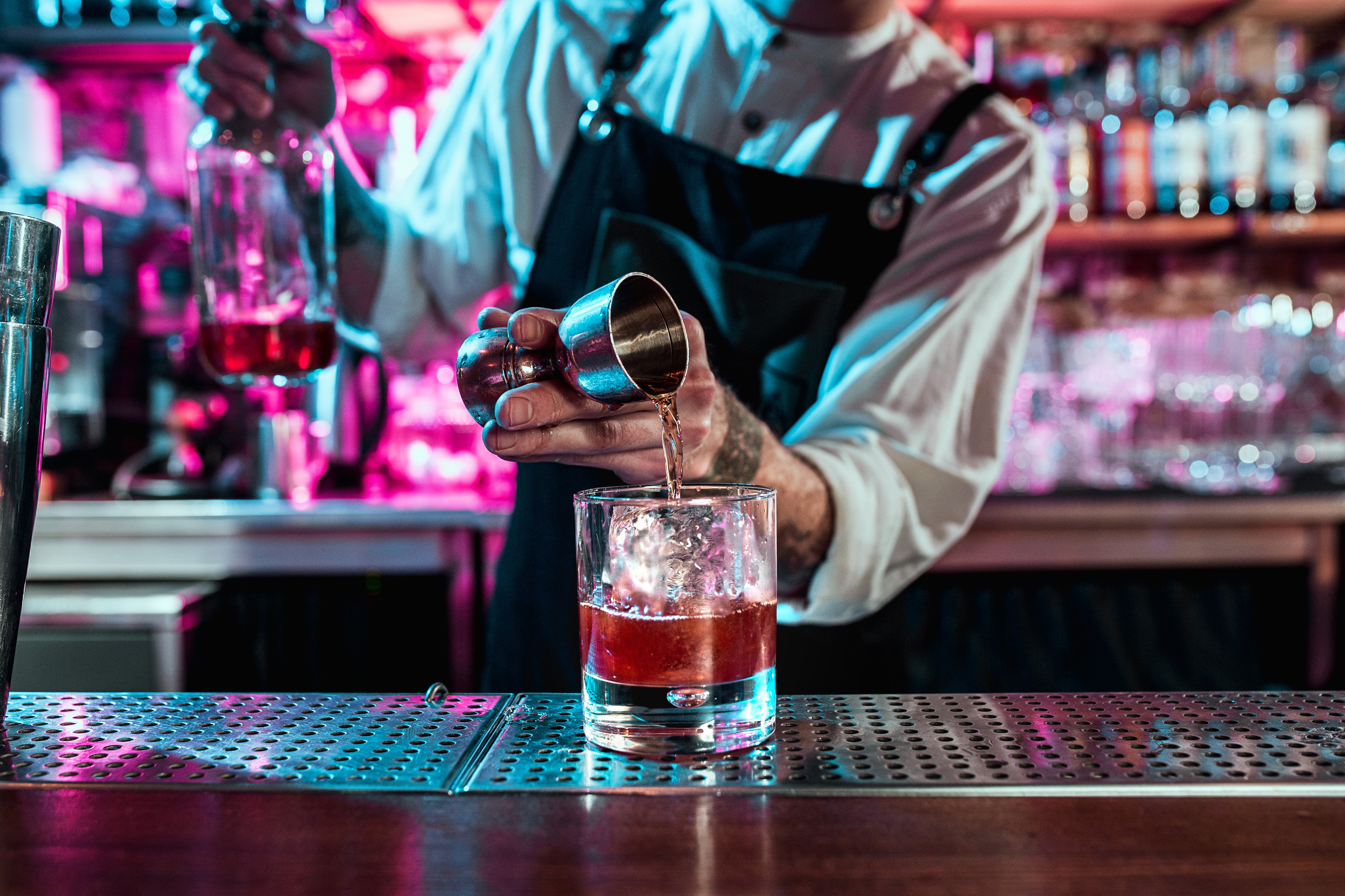 man mixing a cocktail at a bar