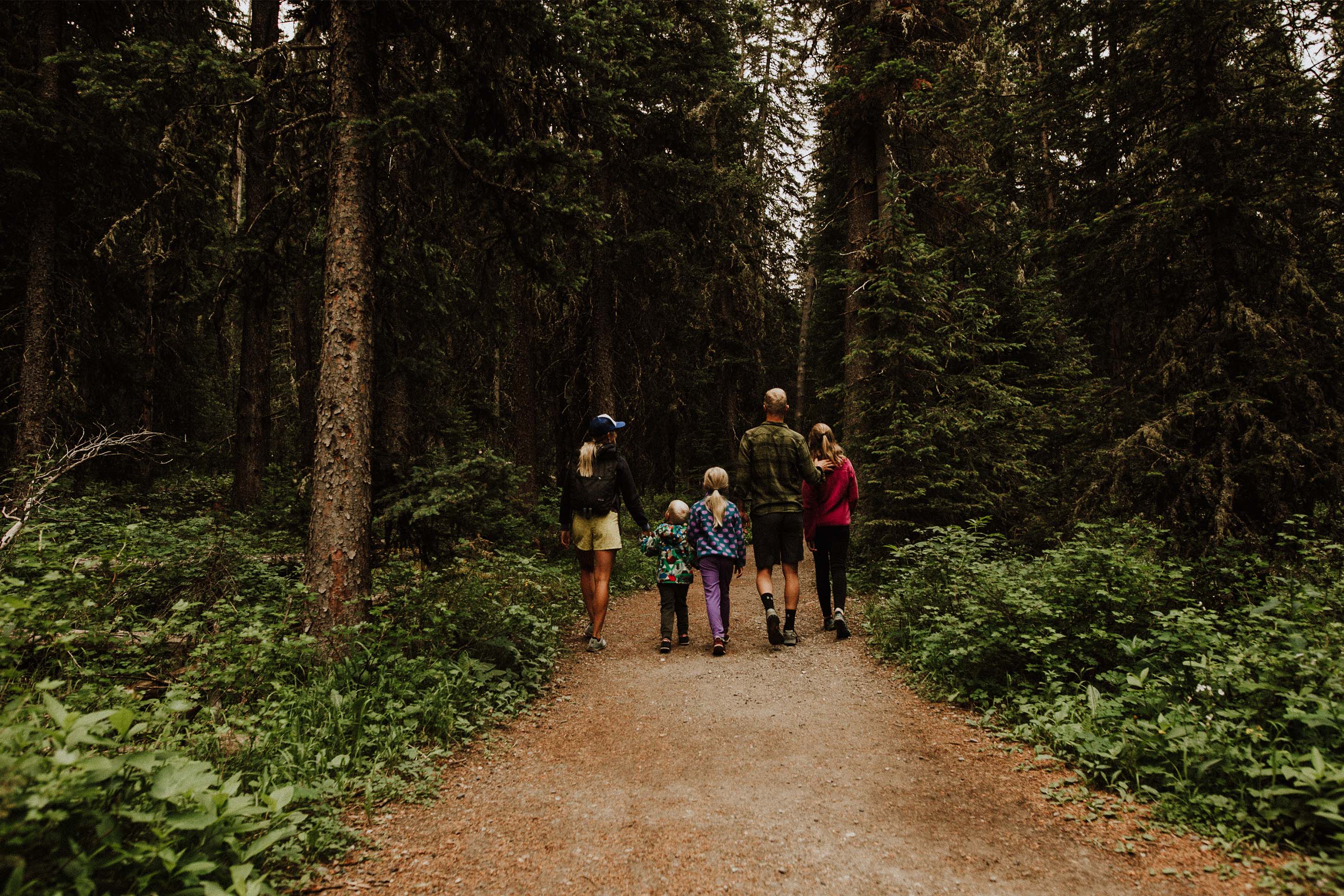 Family walking down a trail together in Bozeman