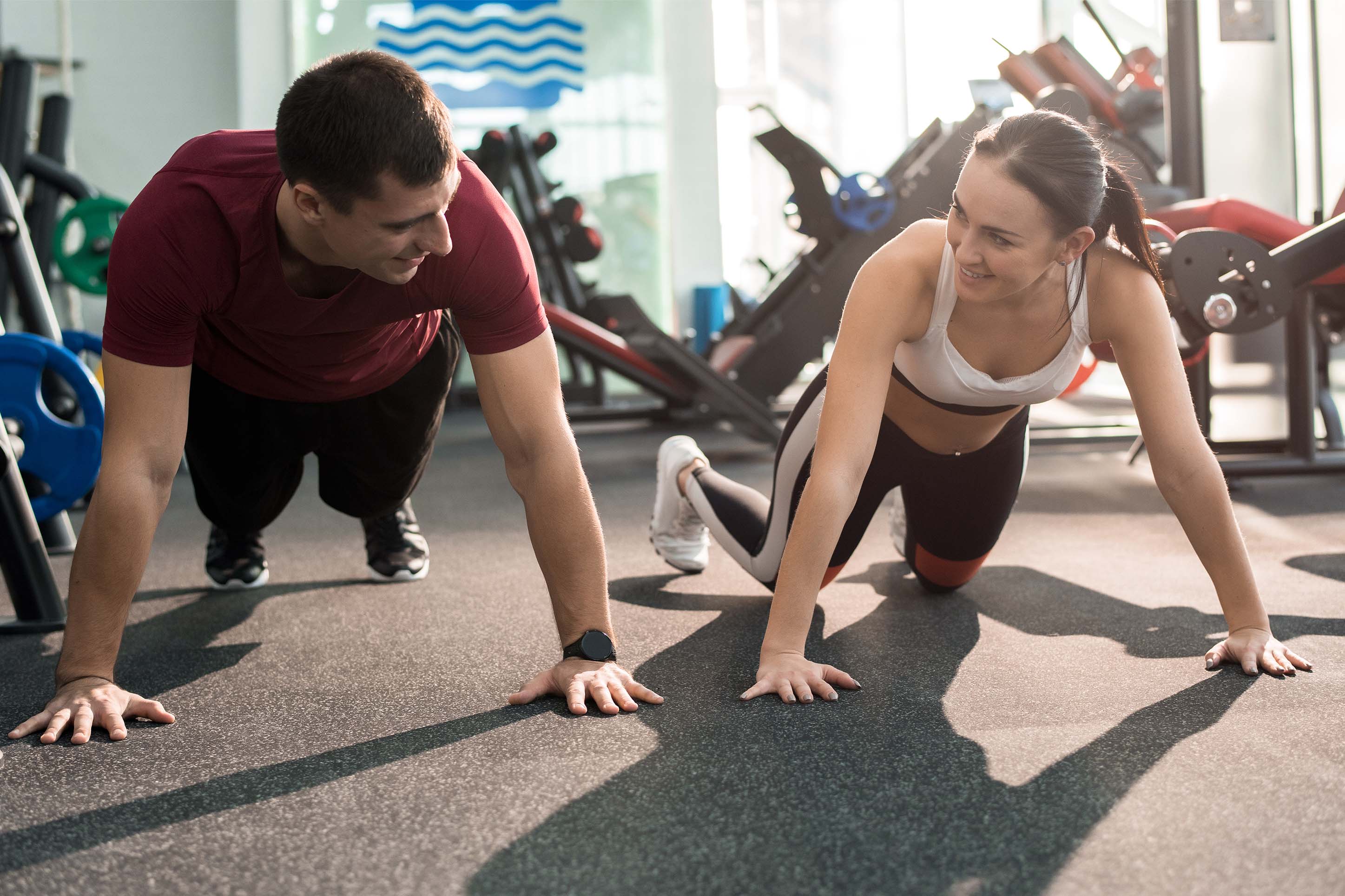 man and woman doing push ups at a gym in Bozeman