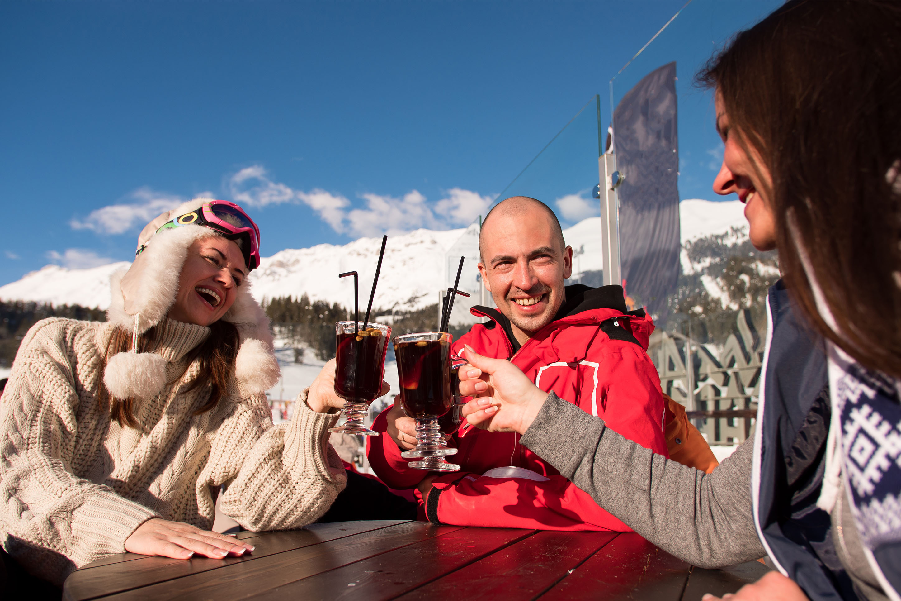 photo of people clinking glasses after a day of skiing