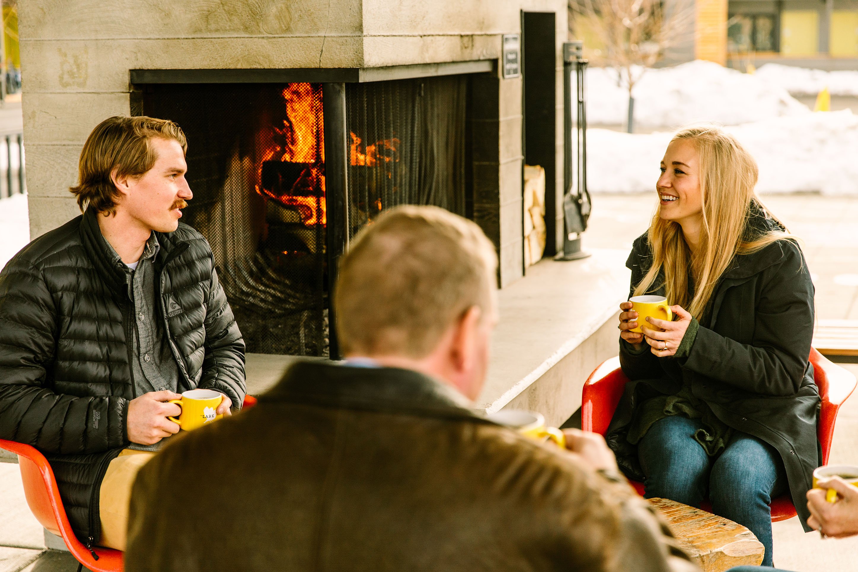 photo of a couple by an outdoor fireplace