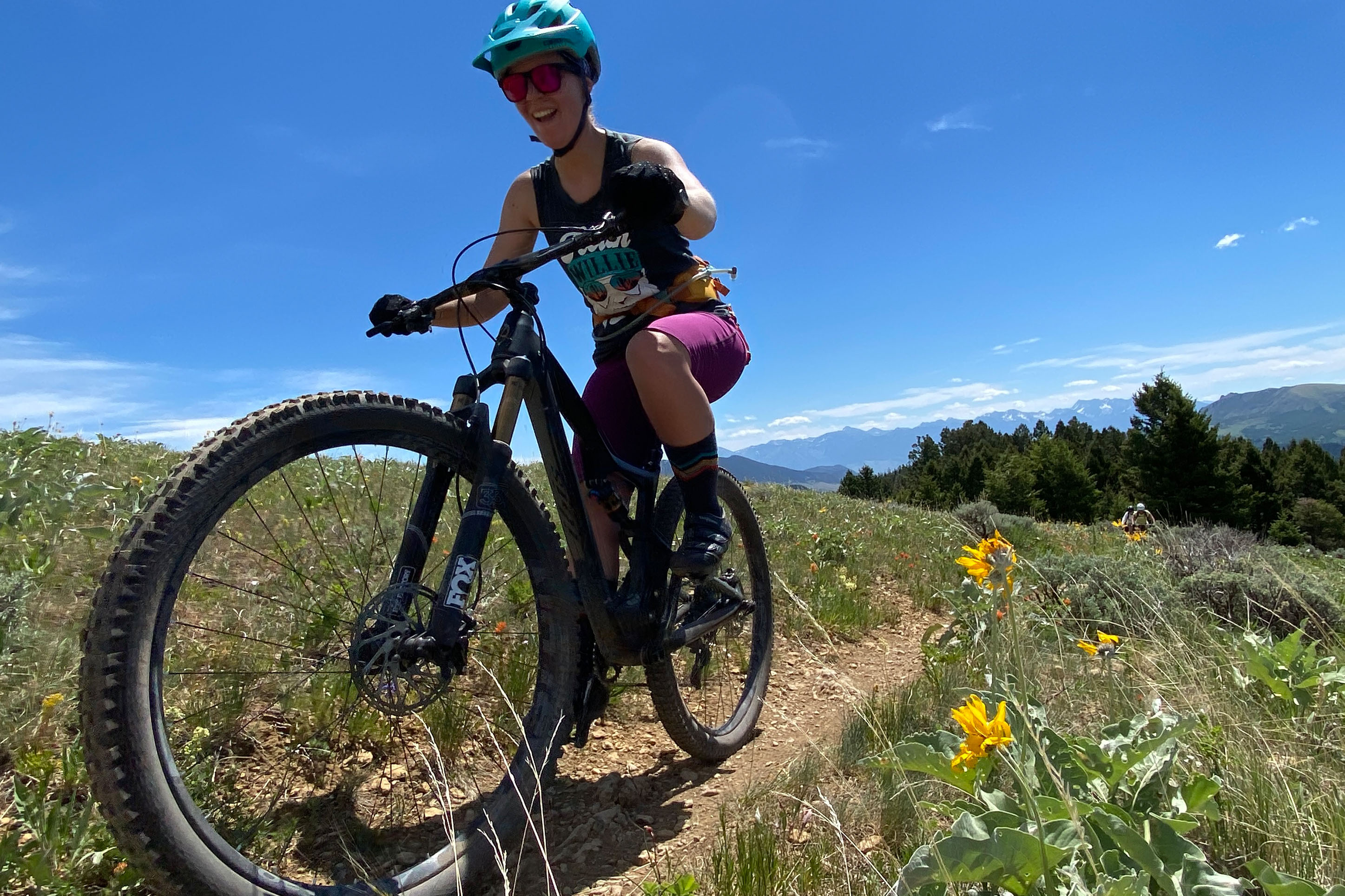 Mountain biker on a trail witih wildflowers. 