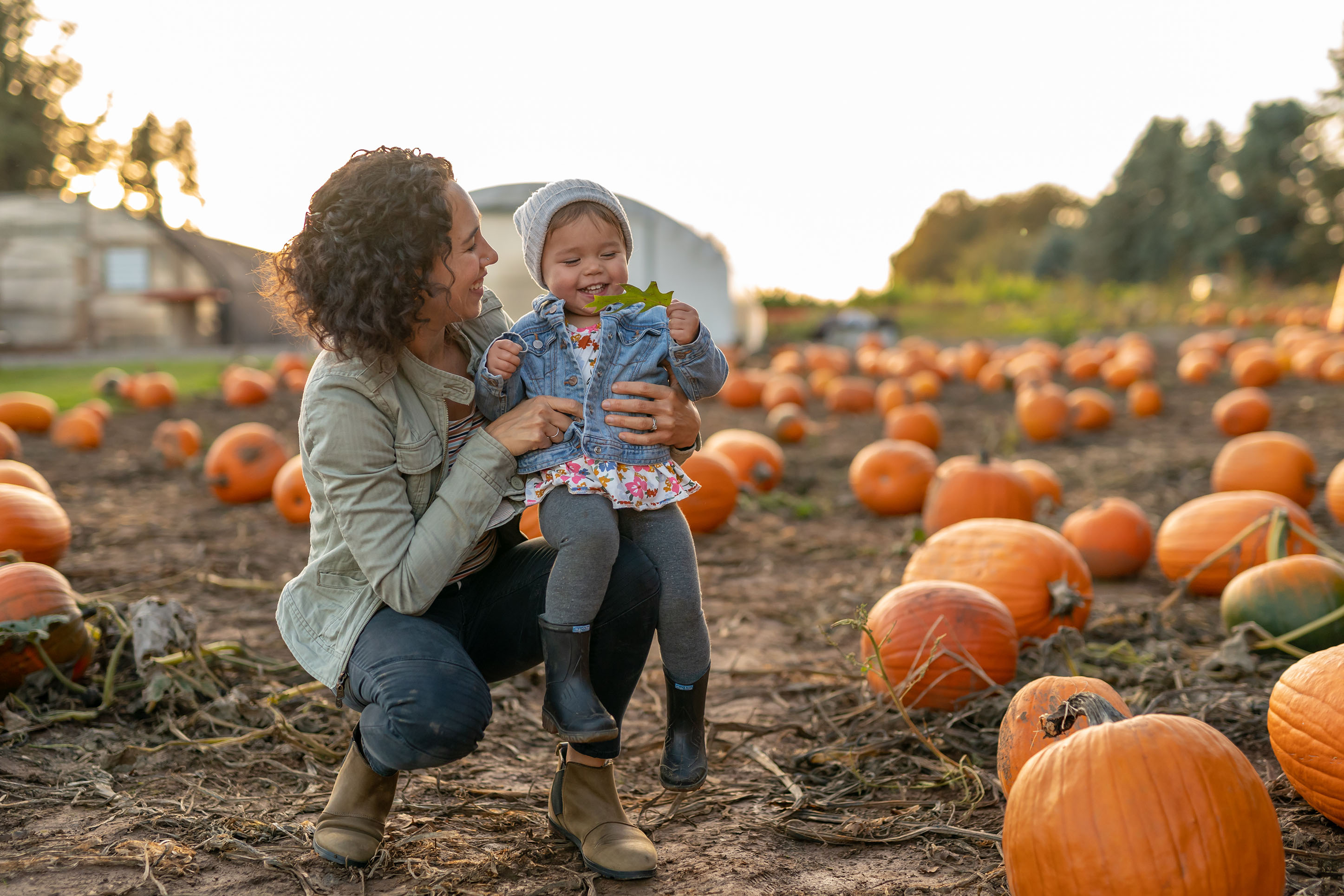 Photo of a mother and daughter in a pumpkin patch