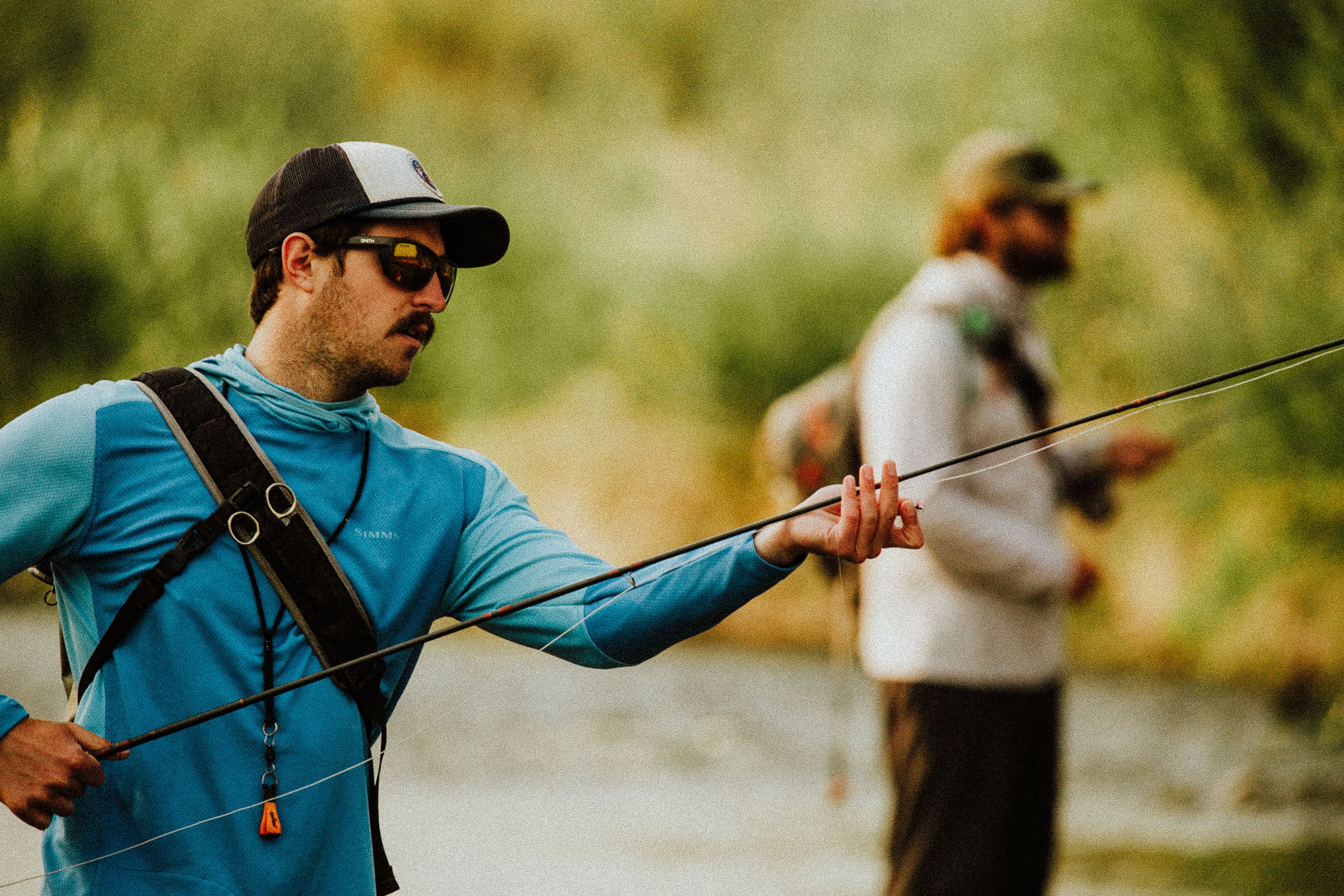 Image of two men fly fishing.
