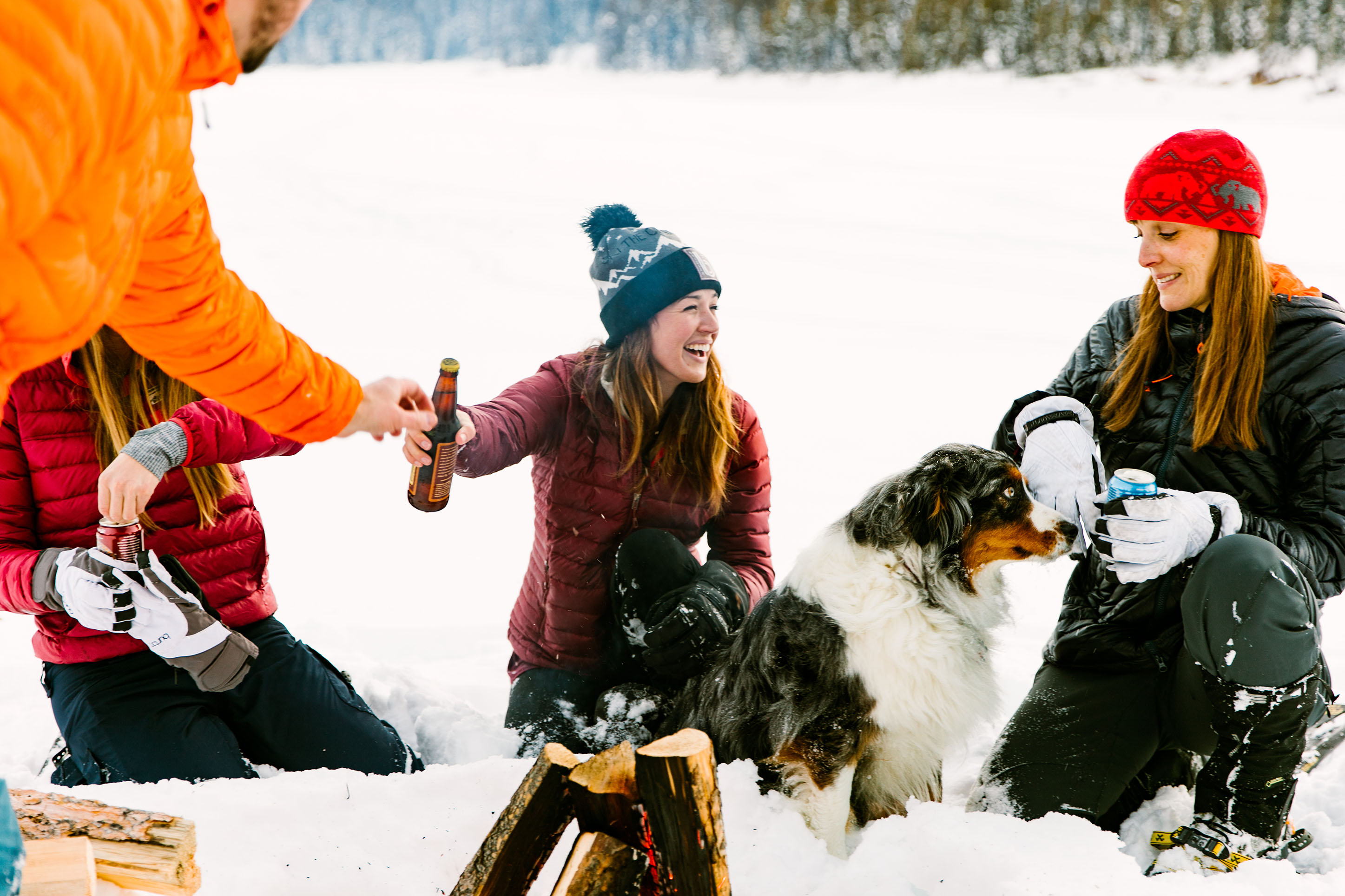 Friends enjoying a winter bonfire and beer.