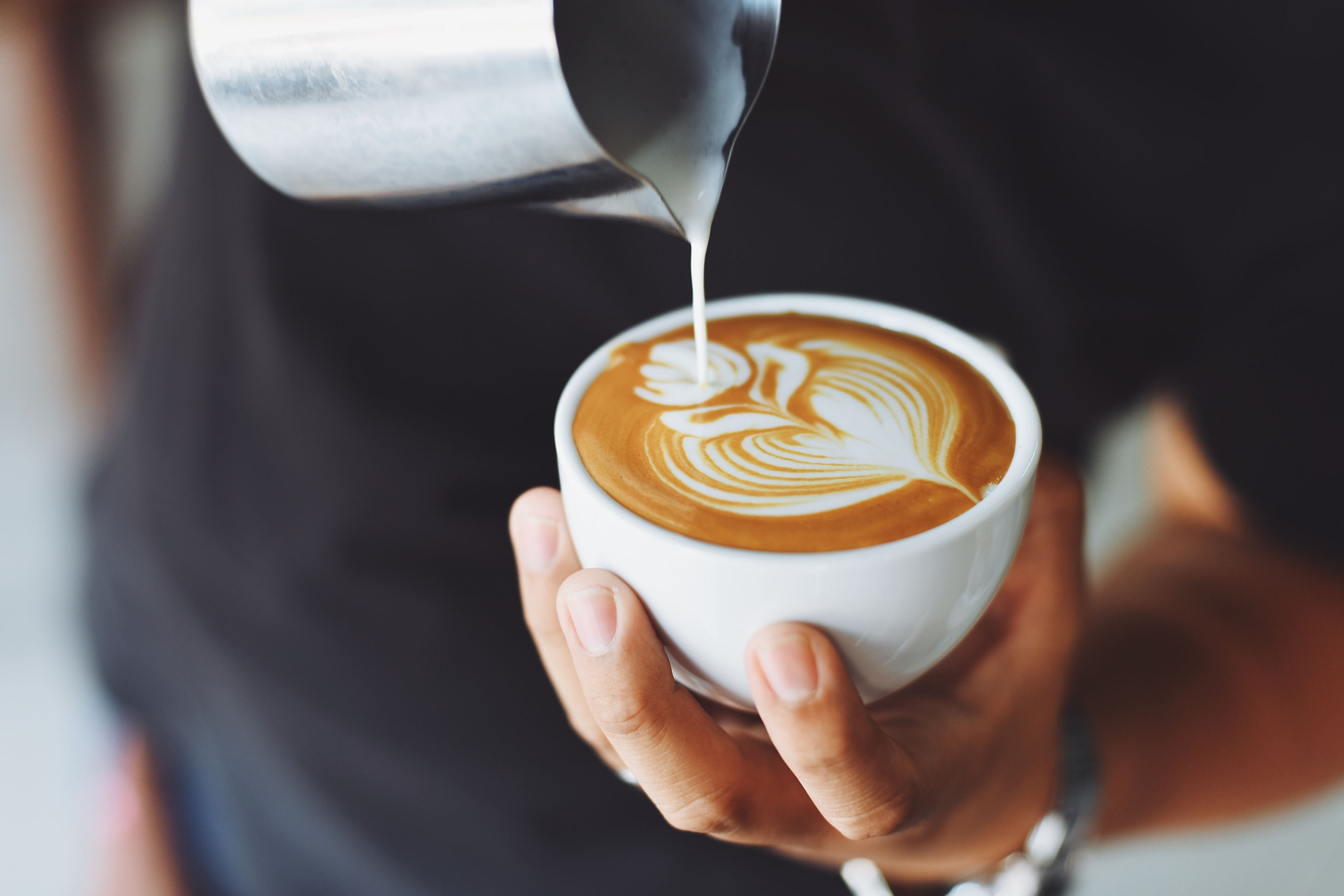 Photo of a latte with a design in milk