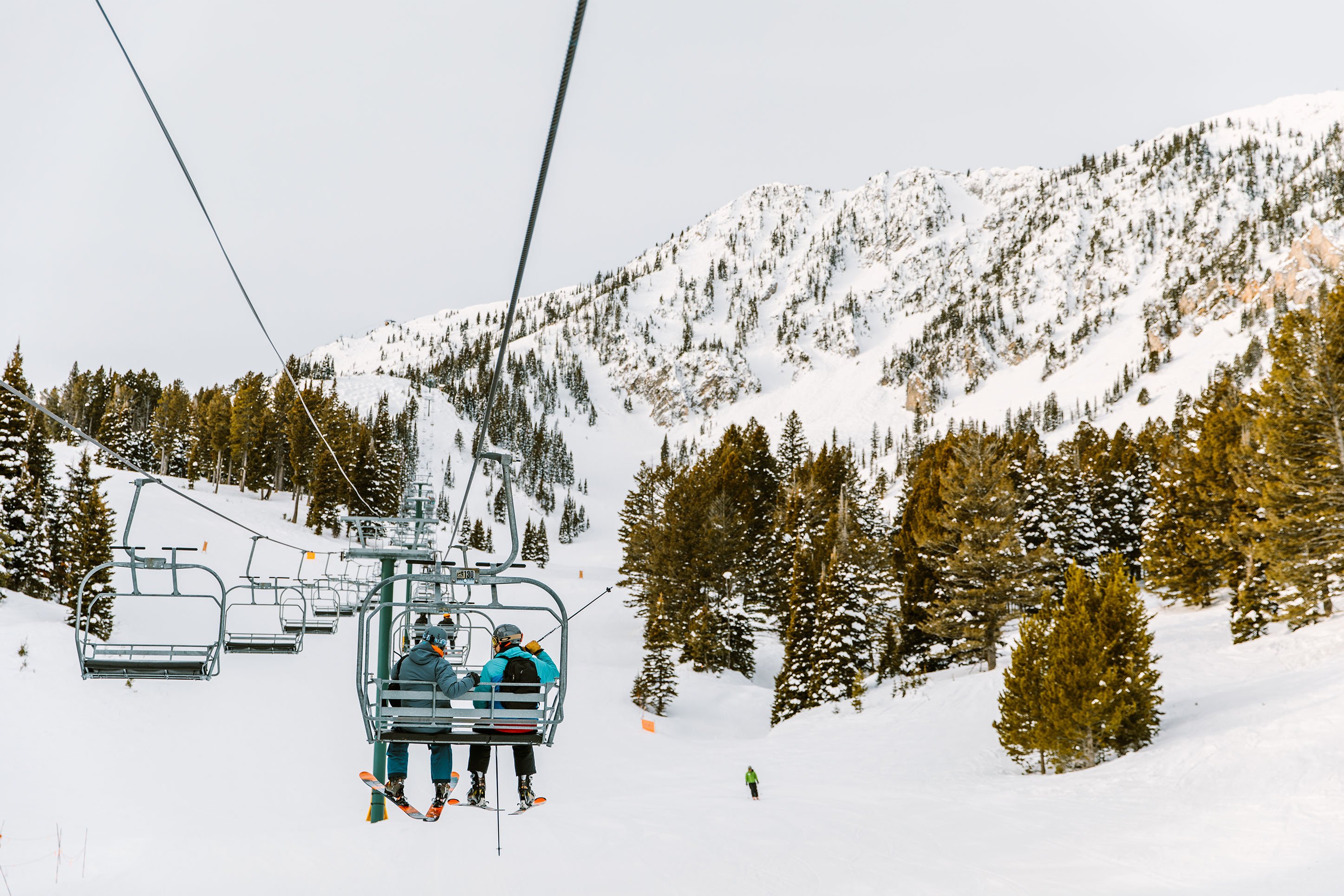 Skiers on a chairlift at Bridger Bowl Ski Area 