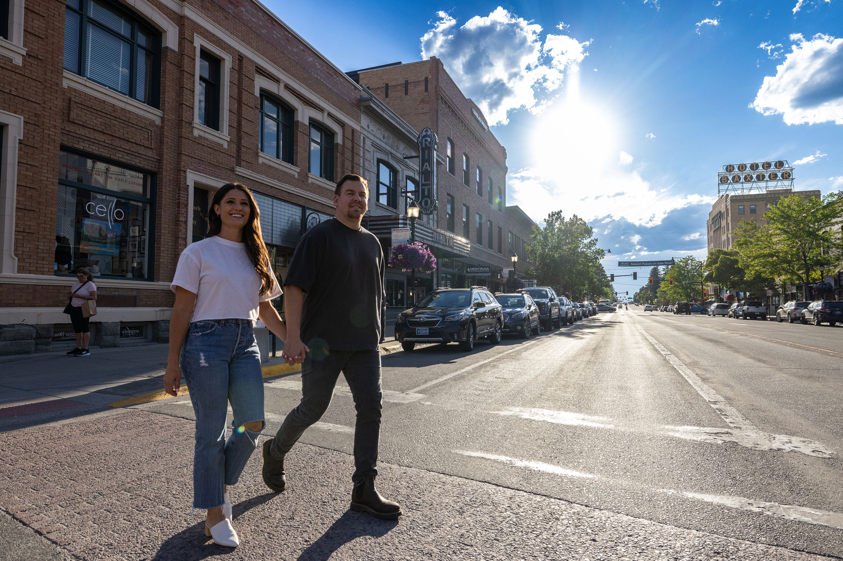 Photo of a couple walking across Main Street in summertime