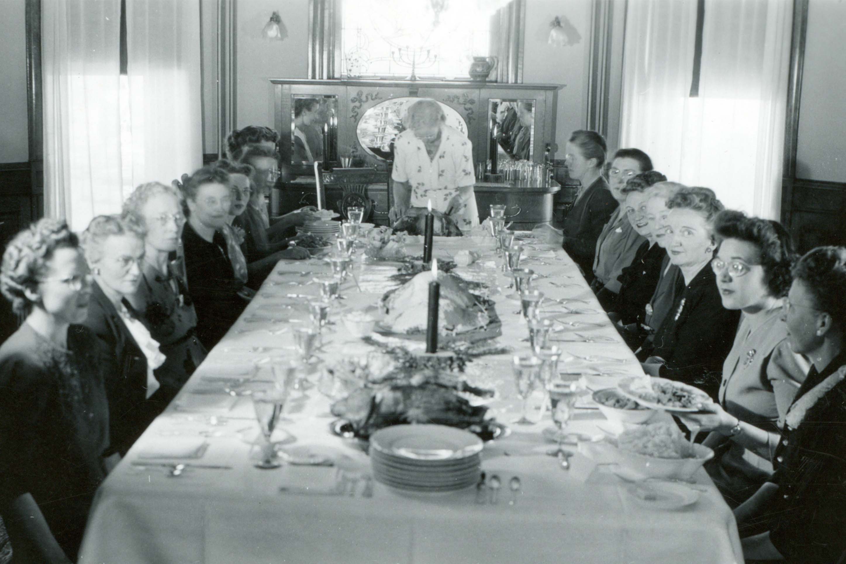 Julia Martin and guests at one of her annual Thanksgiving Day dinners, circa 1940s or 1950s.