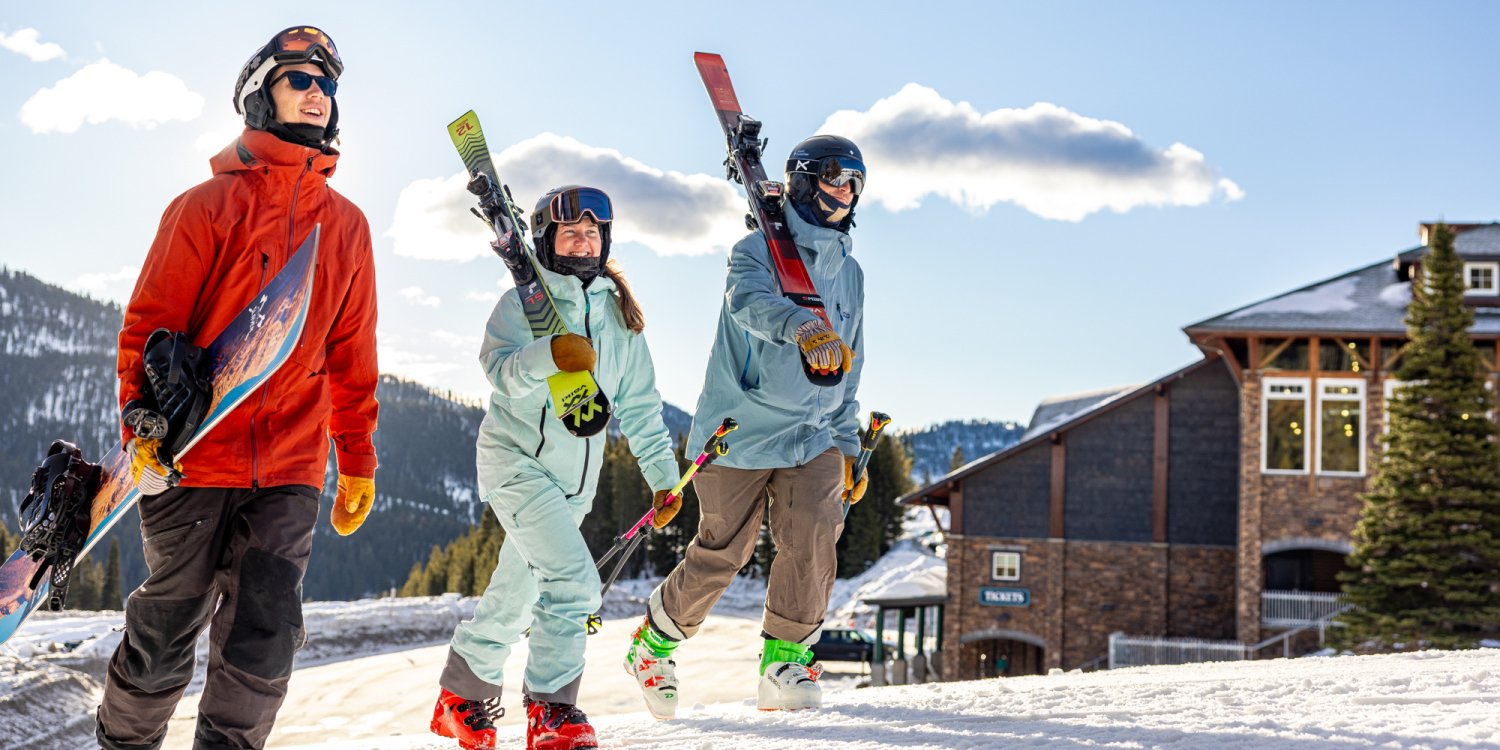 Family walking with skis at Bridger Bowl Ski Area.